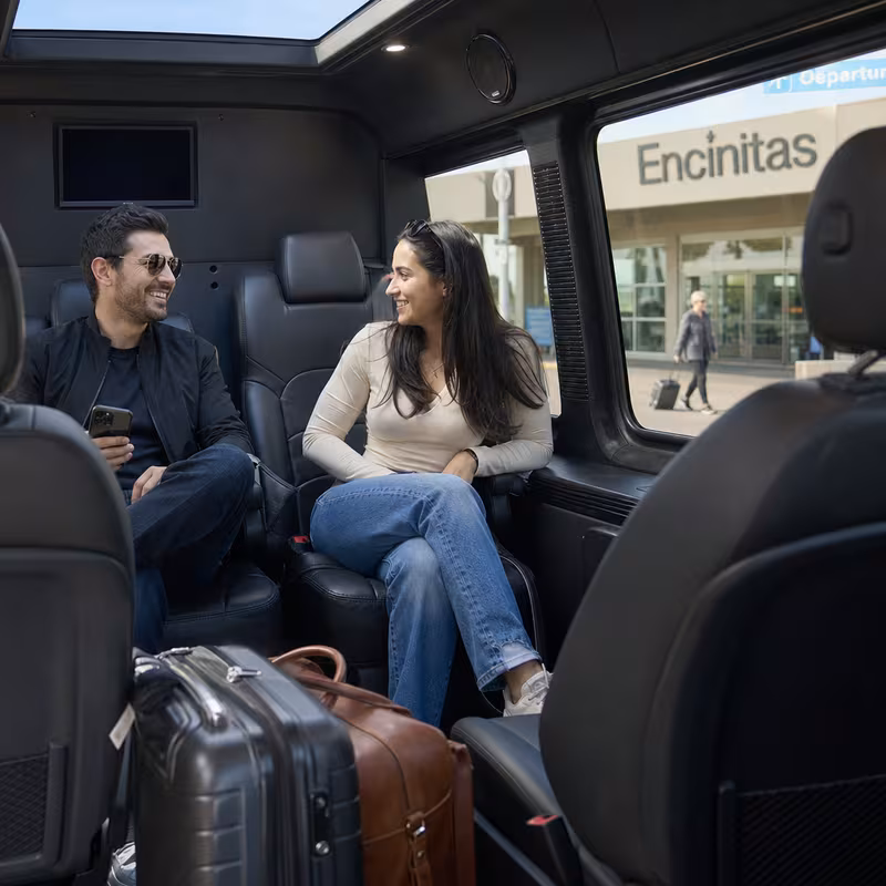 Passengers loading luggage while boarding an Encinitas group shuttle