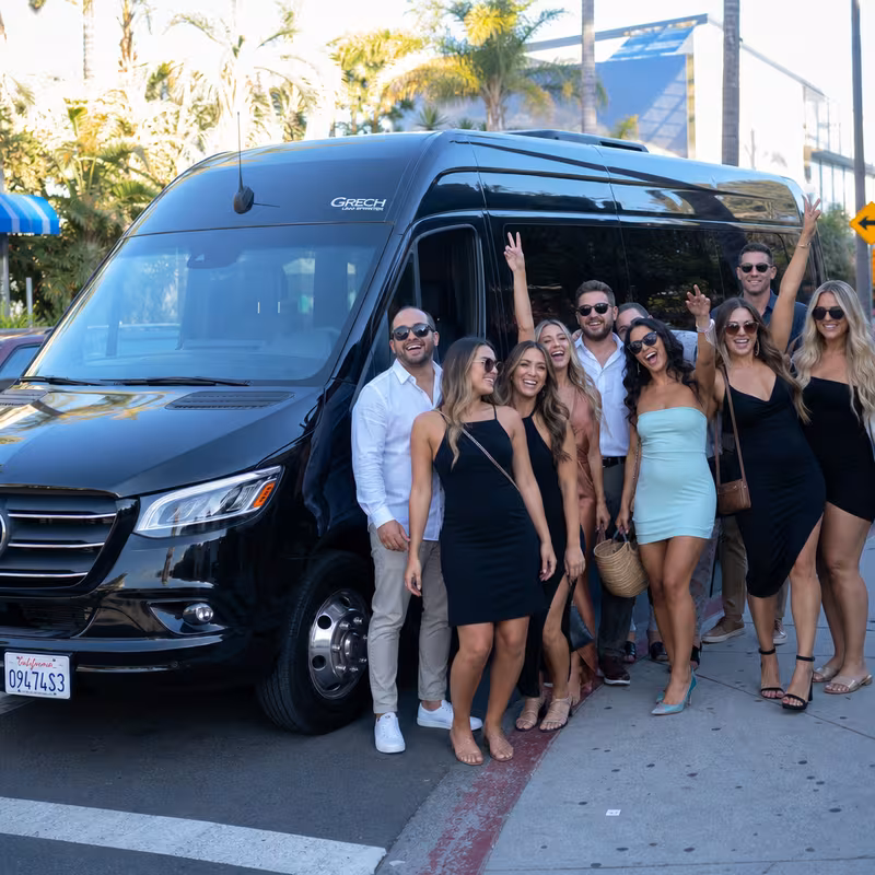 Group boarding a white charter bus for Bachelor & Bachelorette Transportation transportation in Encinitas