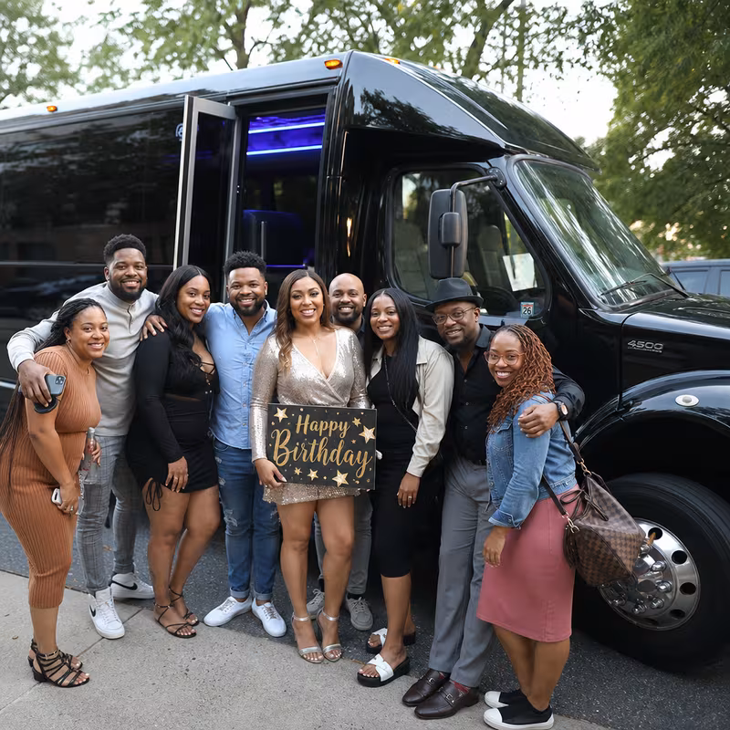 Group boarding a white charter bus for Birthday Transportation transportation in Encinitas