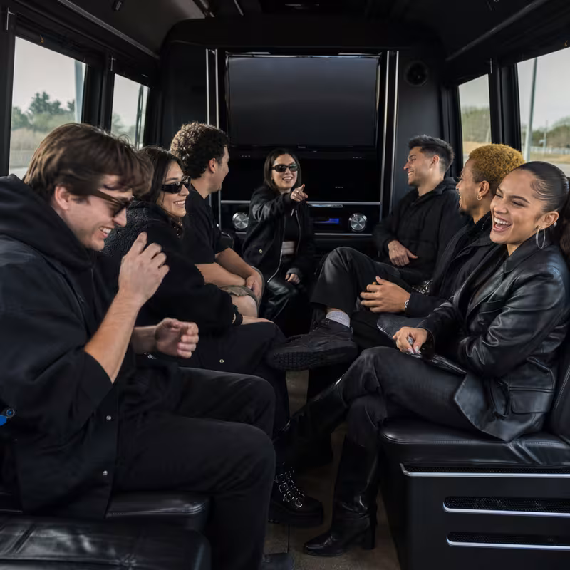 Group boarding a white charter bus for Concert Transportation transportation in Encinitas