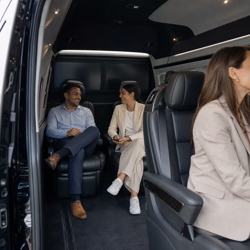Group boarding a white charter bus for Corporate Transportation transportation in Encinitas