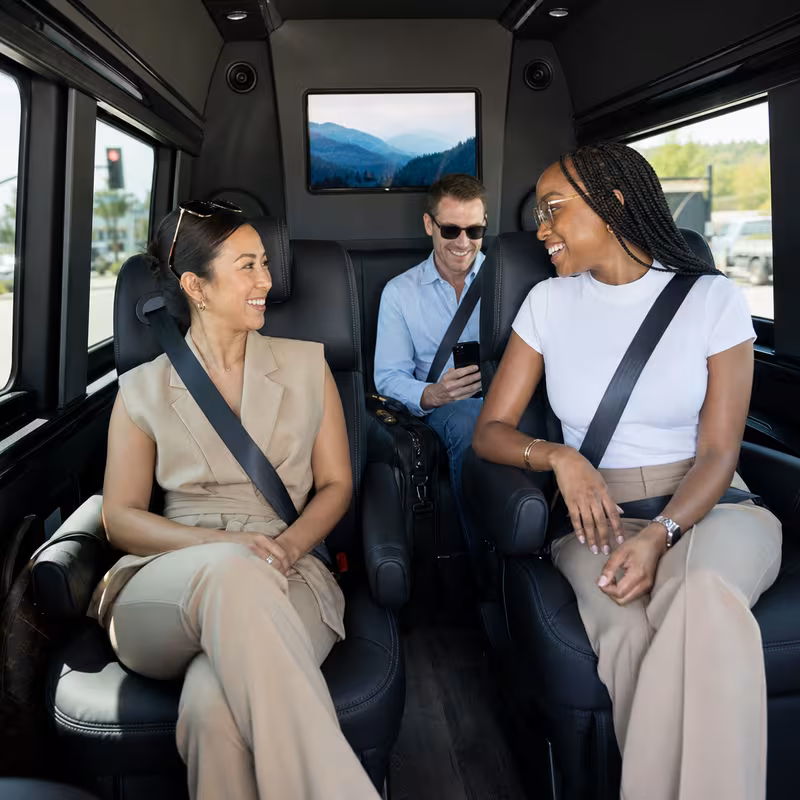 Passengers loading luggage while boarding an Encinitas group shuttle
