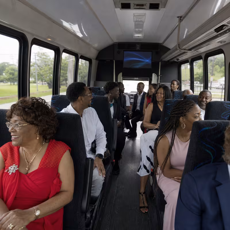 Group boarding a white charter bus for Private Event Transportation transportation in Encinitas