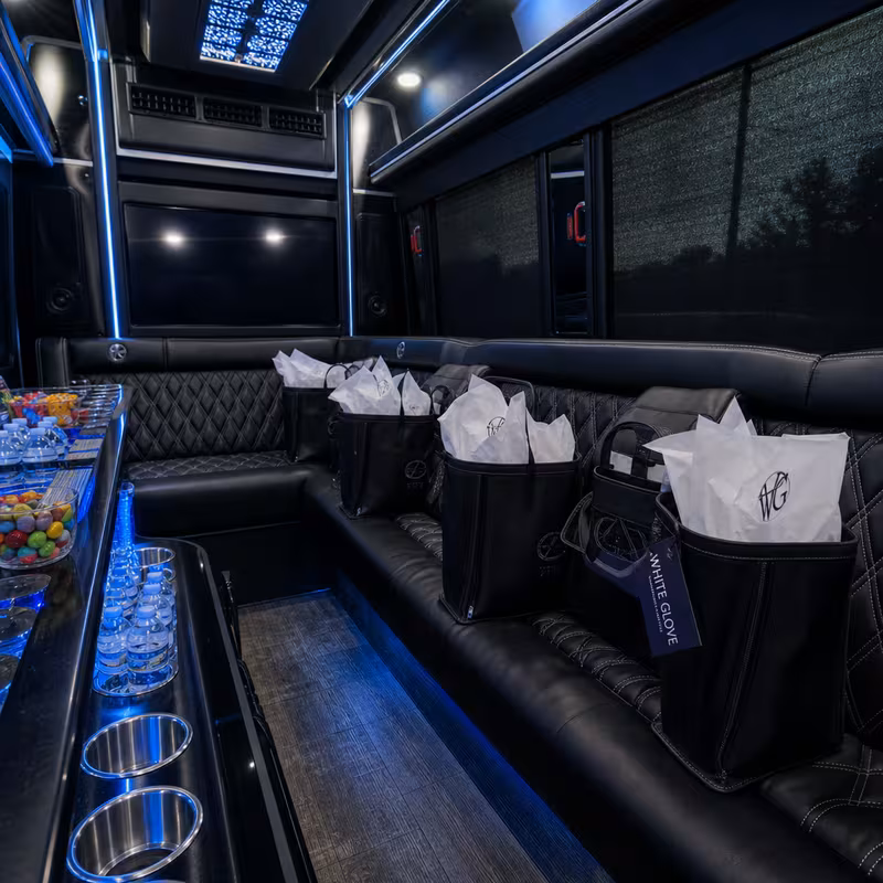 Party bus interior with wraparound leather seating and LED lighting in Encinitas